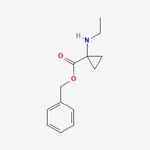 molecular formula C13H17NO2 B8125011 Benzyl 1-(ethylamino)cyclopropanecarboxylate 
