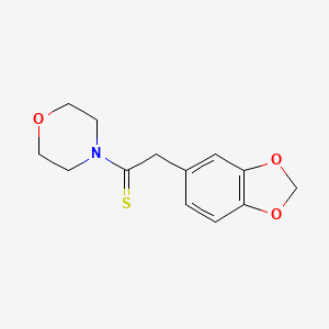 molecular formula C13H15NO3S B8139814 2-(1,3-Benzodioxol-5-yl)-1-morpholin-4-ylethanethione 