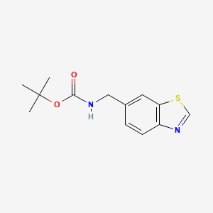 molecular formula C13H16N2O2S B8146653 Carbamic acid, N-(6-benzothiazolylmethyl)-, 1,1-dimethylethyl ester 