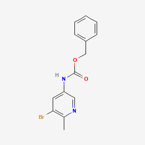 molecular formula C14H13BrN2O2 B8147408 benzyl N-(5-bromo-6-methylpyridin-3-yl)carbamate 