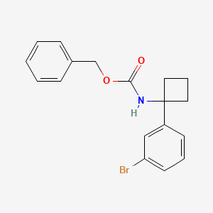 molecular formula C18H18BrNO2 B8147728 benzyl N-[1-(3-bromophenyl)cyclobutyl]carbamate 
