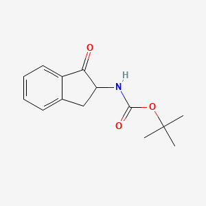 molecular formula C14H17NO3 B8148148 tert-butyl N-(1-oxo-2,3-dihydro-1H-inden-2-yl)carbamate 