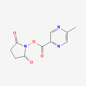 molecular formula C10H9N3O4 B8151186 5-Methyl-pyrazine-2-carboxylic acid 2,5-dioxo-pyrrolidin-1-yl ester 