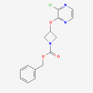 molecular formula C15H14ClN3O3 B8160438 Benzyl 3-(3-chloropyrazin-2-yloxy)azetidine-1-carboxylate 
