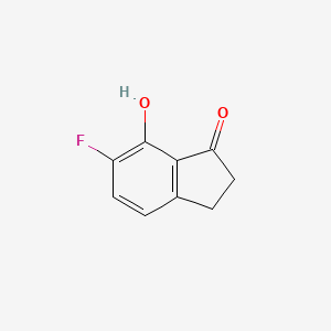 molecular formula C9H7FO2 B8185088 6-Fluoro-7-hydroxy-indan-1-one 