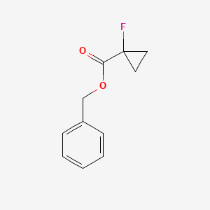 molecular formula C11H11FO2 B8185474 1-Fluoro-cyclopropanecarboxylic acid benzyl ester 