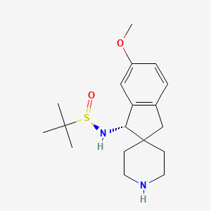 molecular formula C18H28N2O2S B8189578 (1S)-1-[[(R)-tert-butylsulfinyl]amino]-6-methoxy-spiro[indane-2,4'-piperidine] 
