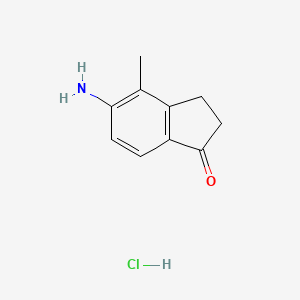 molecular formula C10H12ClNO B8212201 5-amino-4-methyl-2,3-dihydro-1H-inden-1-one hydrochloride 