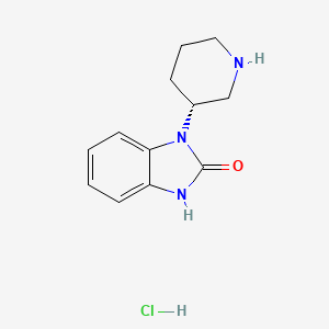 molecular formula C12H16ClN3O B8214879 1-[(3R)-piperidin-3-yl]-2,3-dihydro-1H-1,3-benzodiazol-2-one hydrochloride 