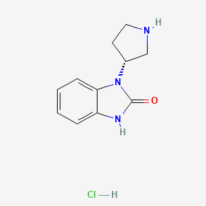 molecular formula C11H14ClN3O B8214934 1-[(3R)-pyrrolidin-3-yl]-2,3-dihydro-1H-1,3-benzodiazol-2-one hydrochloride 
