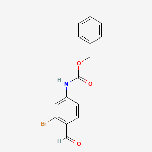 molecular formula C15H12BrNO3 B8230461 benzyl N-(3-bromo-4-formylphenyl)carbamate 