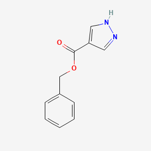 molecular formula C11H10N2O2 B8232205 (phenylmethyl) 1~{H}-pyrazole-4-carboxylate 