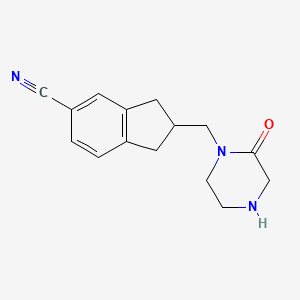 molecular formula C15H17N3O B8289218 2-[(2-Oxopiperazin-1-yl)methyl]indane-5-carbonitrile 