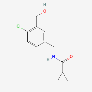 molecular formula C12H14ClNO2 B8311225 Cyclopropanecarboxylic acid 4-chloro-3-hydroxymethyl-benzylamide 