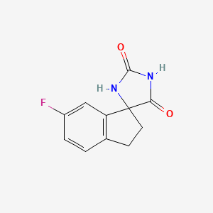 molecular formula C11H9FN2O2 B8332043 6'-Fluoro-spiro[imidazolidine-4,1'-indan]-2,5-dione 