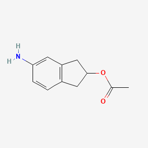 molecular formula C11H13NO2 B8437426 5-Amino-2-acetoxyindane 
