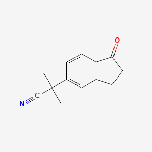 molecular formula C13H13NO B8479893 2-Methyl-2-(1-oxo-2,3-dihydro-1H-inden-5-yl)propanenitrile 