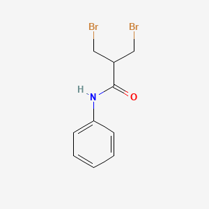 3-Bromo-2-(bromomethyl)-N-phenylpropanamide