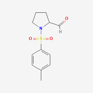 molecular formula C12H15NO3S B8530542 1-[(4-Methylphenyl)sulfonyl] 2-pyrrolidinecarboxaldehyde 