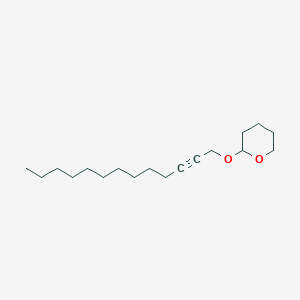 B8564452 2-[(Tridec-2-yn-1-yl)oxy]oxane CAS No. 108604-32-6