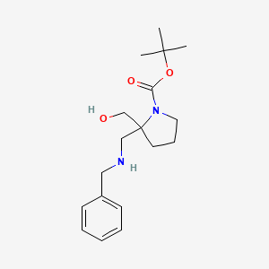 molecular formula C18H28N2O3 B8604042 Tert-butyl 2-[(benzylamino)methyl]-2-(hydroxymethyl)pyrrolidine-1-carboxylate 