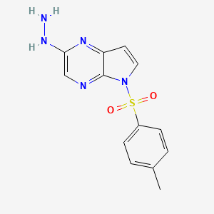 molecular formula C13H13N5O2S B8658733 2-Hydrazinyl-5-tosyl-5H-pyrrolo[2,3-b]pyrazine 