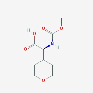 molecular formula C9H15NO5 B8809250 Methyl N-methoxycarbonyl-2-(oxan-4-YL)-L-glycinate 